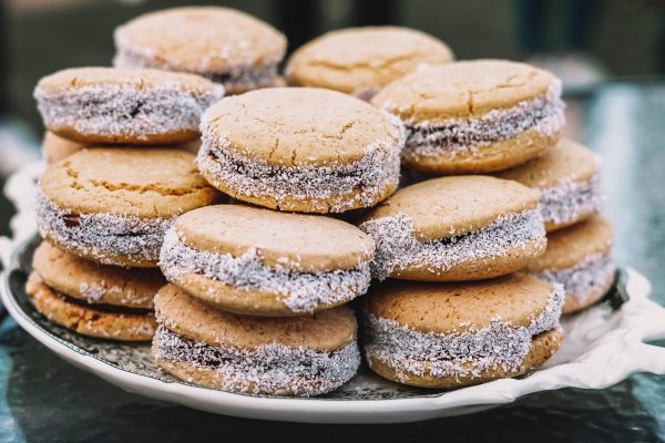 Plate full of cornstarch alfajores filled with dulce de leche. Typical South American dessert.